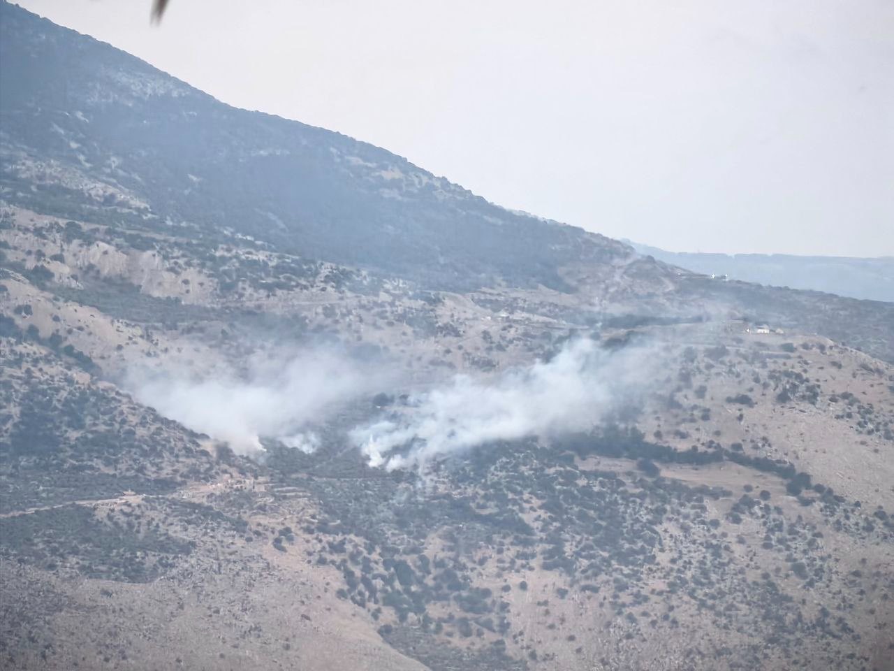 Image in @MarioNawfal's post: 🚨BREAKING: Israeli artillery bombards the Bastra area in Shebaa Farms, southern Lebanon