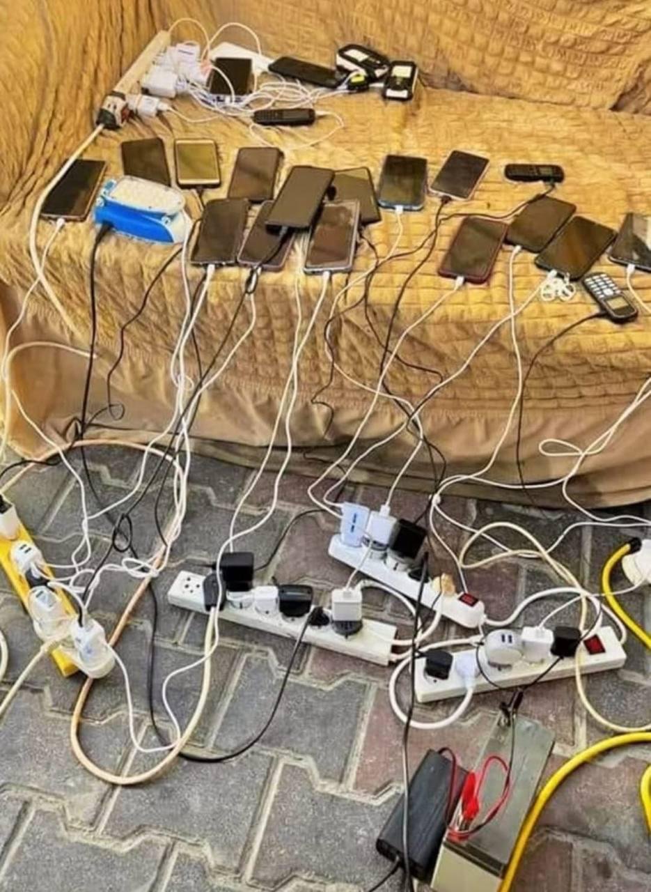 Image in @MarioNawfal's post: 🚨JUST IN: Palestinians in Gaza are charging their phones using car batteries as a result of the sec…