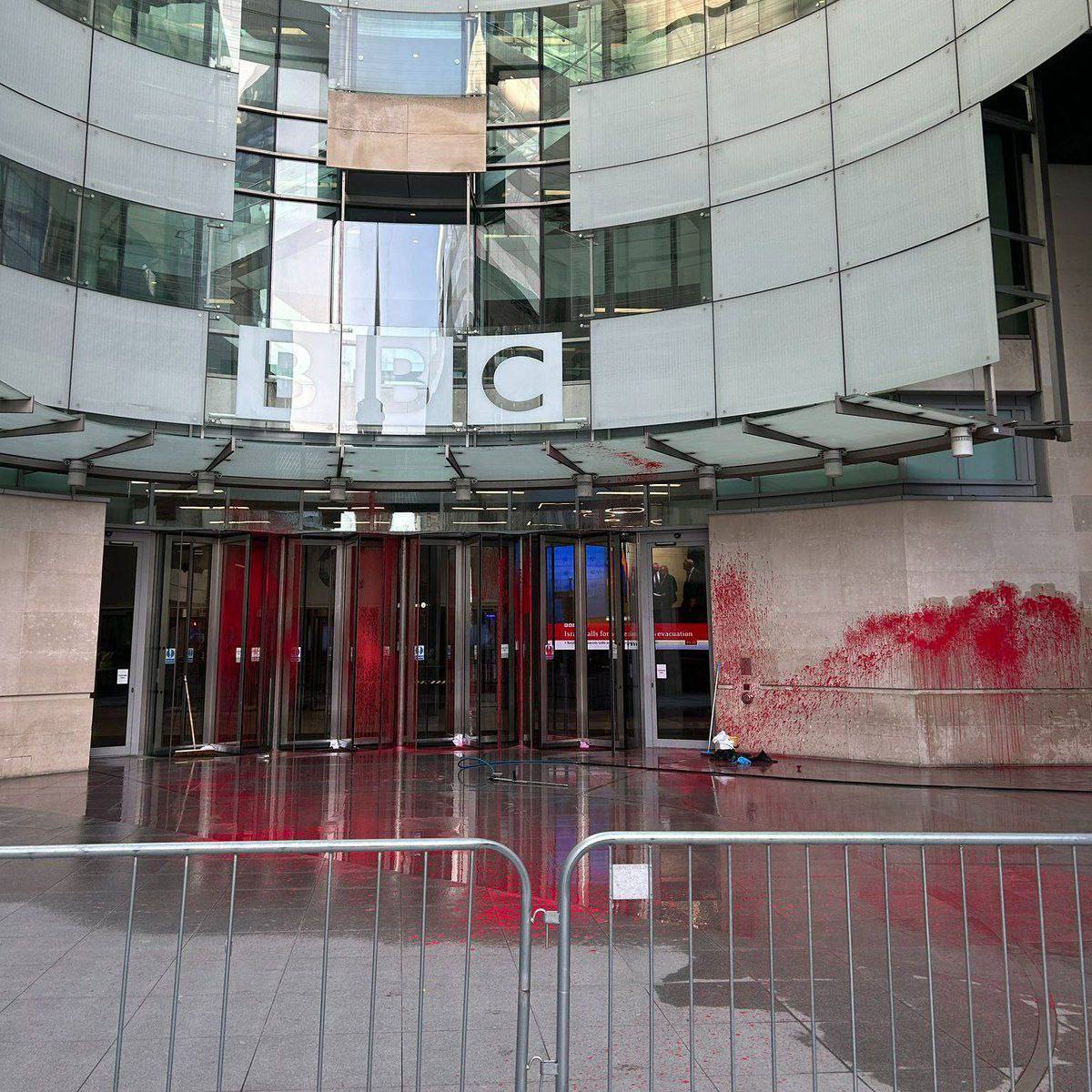 Image in @MarioNawfal's post: 🚨JUST IN - Activists in the UK spray BBC premises with red paint in protest of its adoption of the …