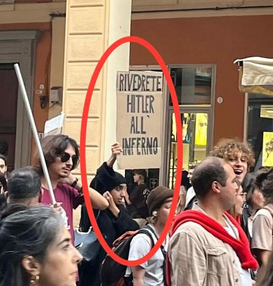 Image in @MarioNawfal's post: 🇮🇱🇮🇹An Italian woman holds a sign that reads "in hell you will meet Hitler again" at an anti-Israel…